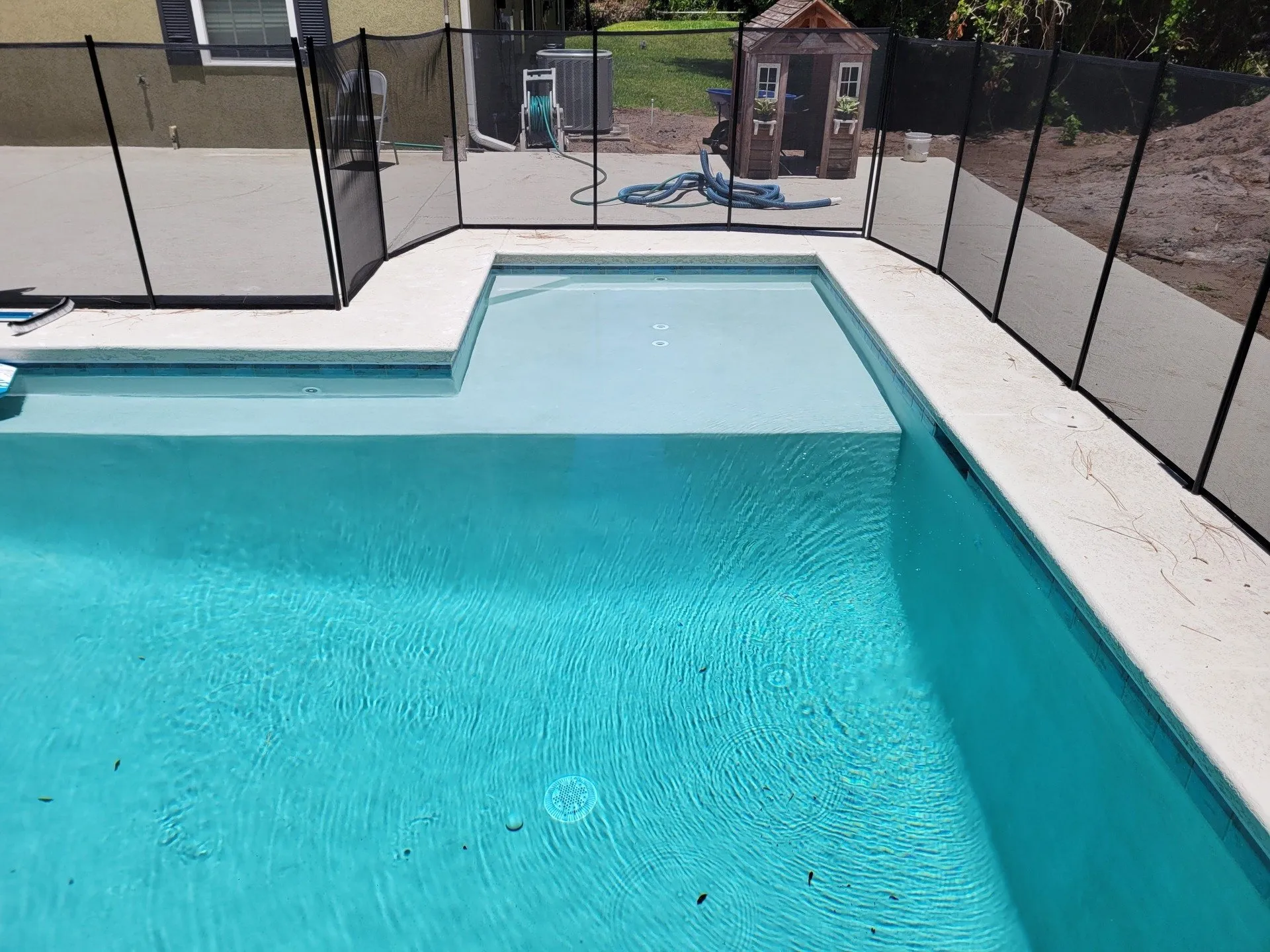 Freshly resurfaced pool with new interior finish and safety fence